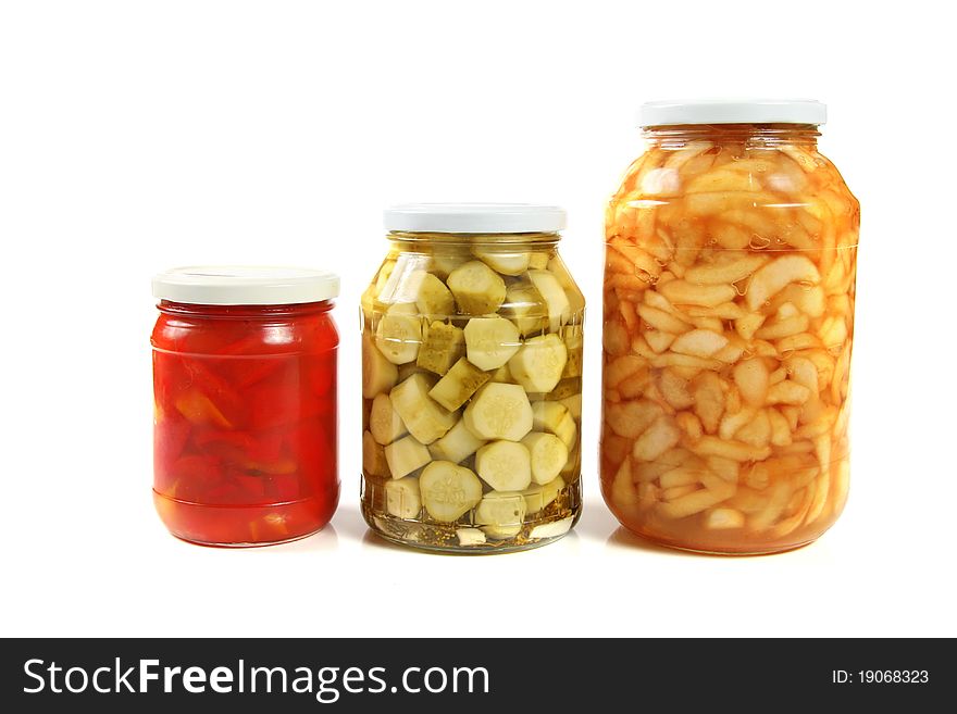 Three jars of pickled vegetables. isolated on white