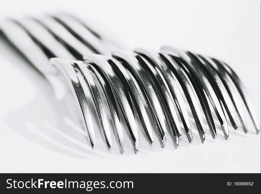 An image of stainless steel forks over a white background