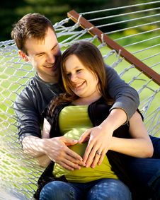 Young Couple Making Heart On Her Pregnant Belly Stock Photo