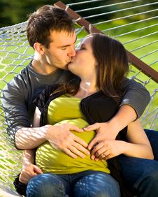 Young Expectant Couple Kissing Stock Photos Young Expectant Couple Kissing Stock Photos