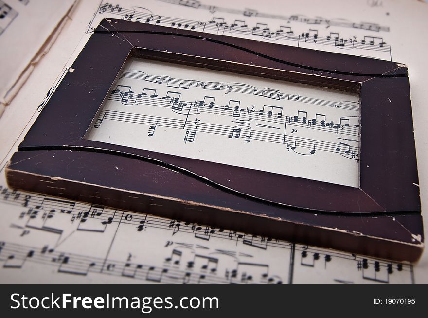 Old brown vintage frame on musical background