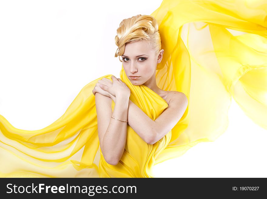 Beautiful Young girl blonde hair in a yellow cloth flying. Beautiful Young girl blonde hair in a yellow cloth flying
