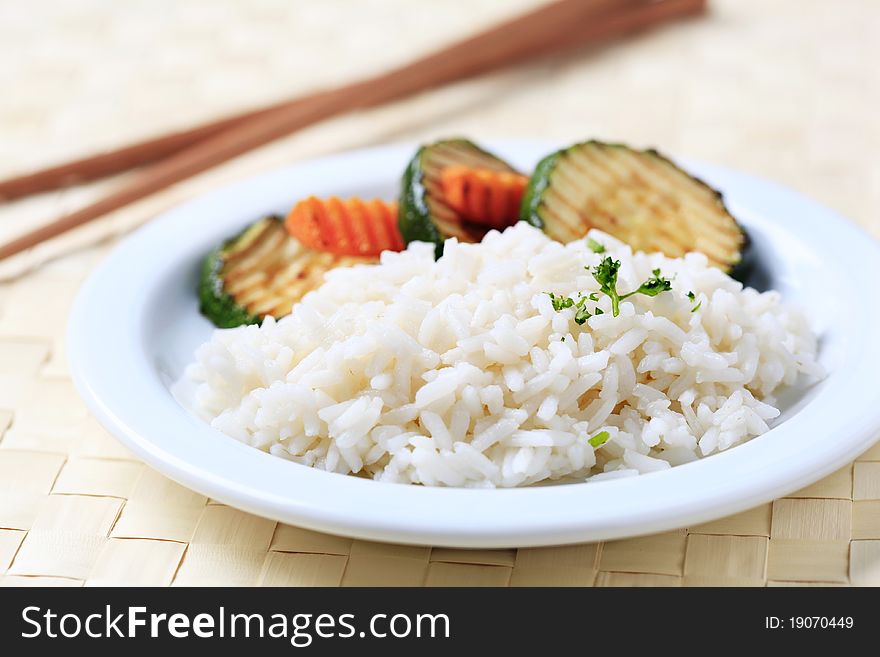 Grilled zucchini and white rice on a plate. Grilled zucchini and white rice on a plate