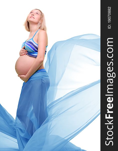 Beautiful young pregnant blonde woman with green transparent cloth in studio. Beautiful young pregnant blonde woman with green transparent cloth in studio