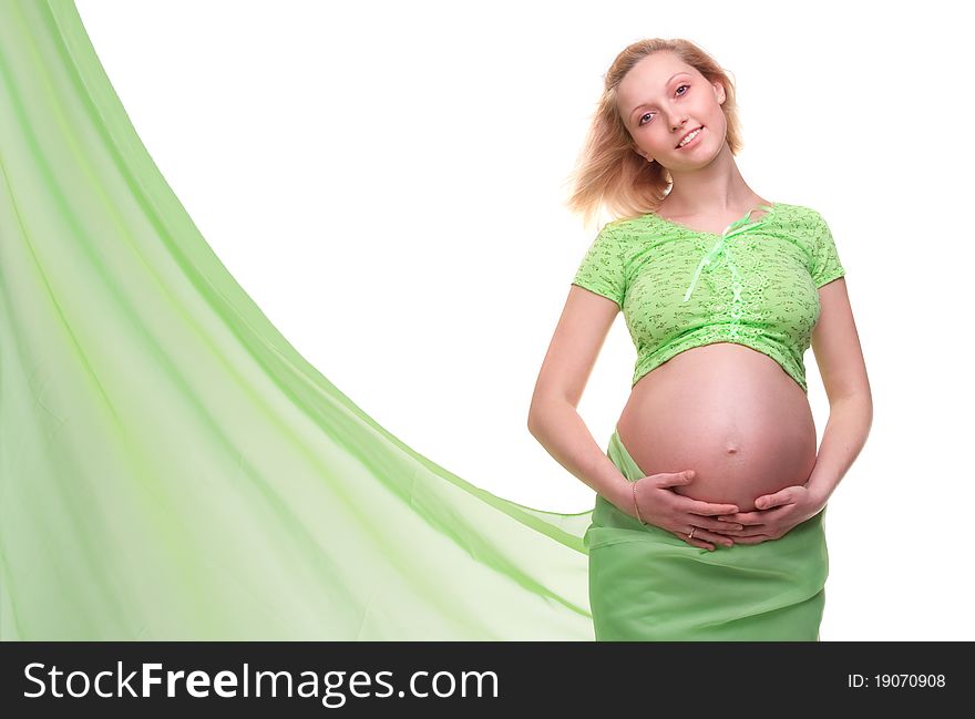 Beautiful young pregnant blonde woman with green transparent cloth in studio. Beautiful young pregnant blonde woman with green transparent cloth in studio