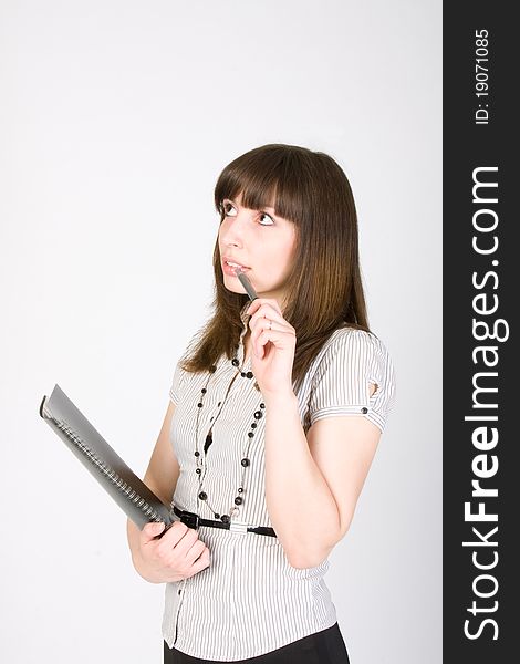 Business woman holding pen and clipboard with thinking expression isolated on white background. Business woman holding pen and clipboard with thinking expression isolated on white background