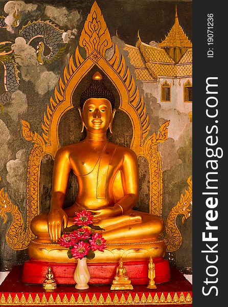 Golden Buddha statue with Thai painting background