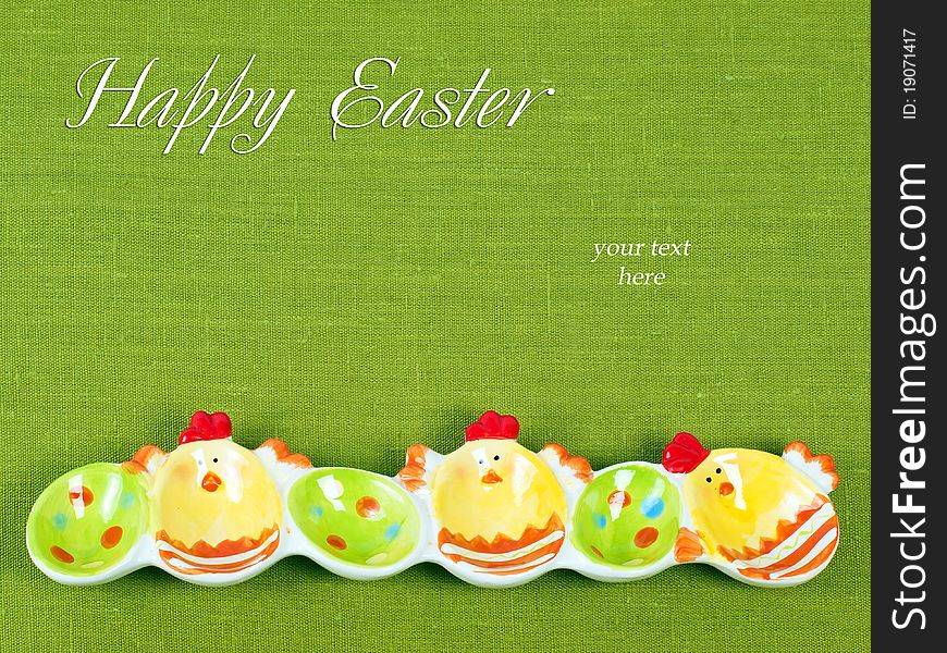 Easter composition: Colorful Easter eggs holder on a green flax background