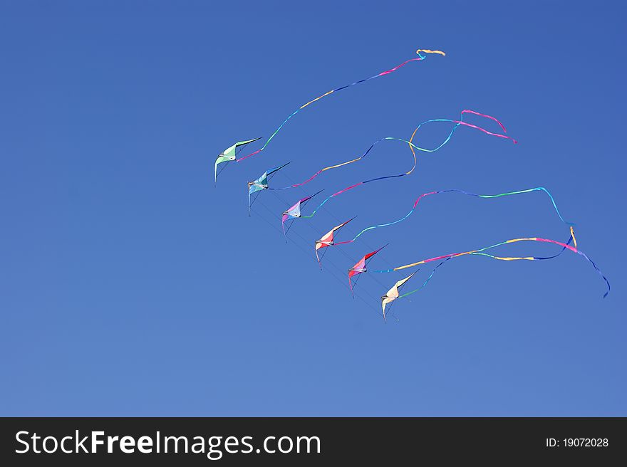 Kites against a vivid blue sky. Selective focus. Kites against a vivid blue sky. Selective focus