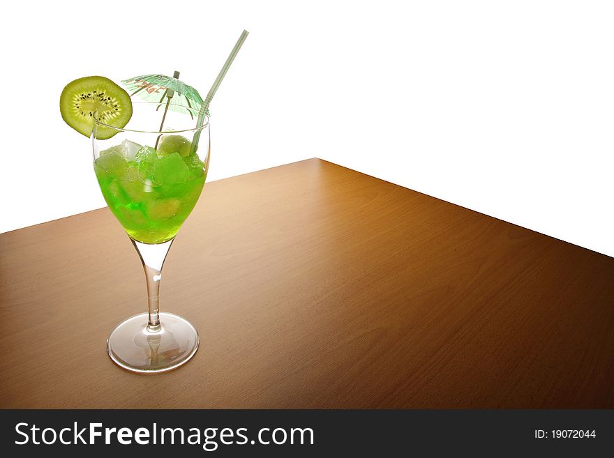Fruit drink with ice is on a wooden table. Fruit drink with ice is on a wooden table