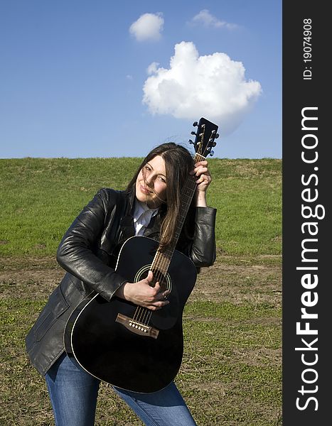 Female artist performer in love with her acoustic guitar. Female artist performer in love with her acoustic guitar.