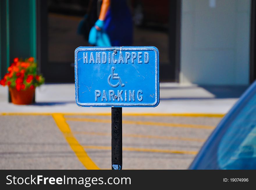 A blue handicapped parking sign with a vintage feel