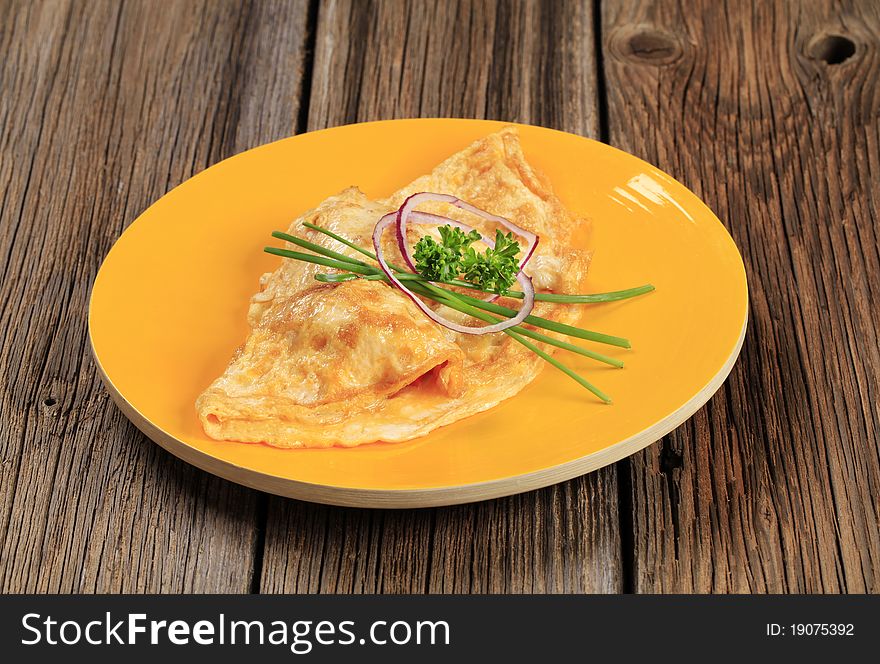 Egg omelet topped with fresh chives and onion