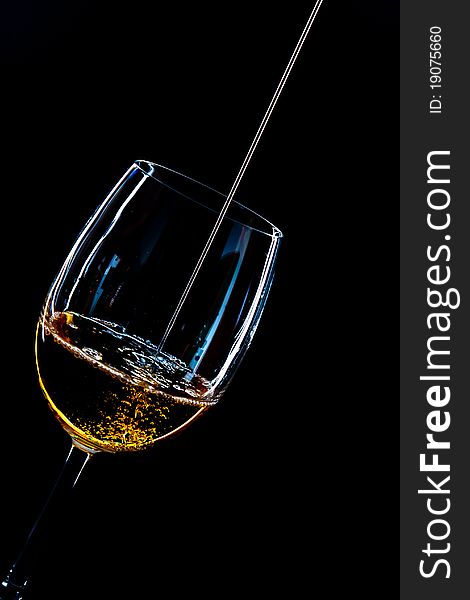 A cup of whisky on black background. A cup of whisky on black background