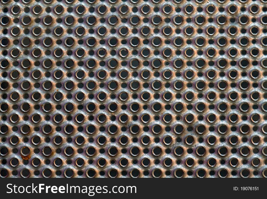 Round perforated metal plate texture