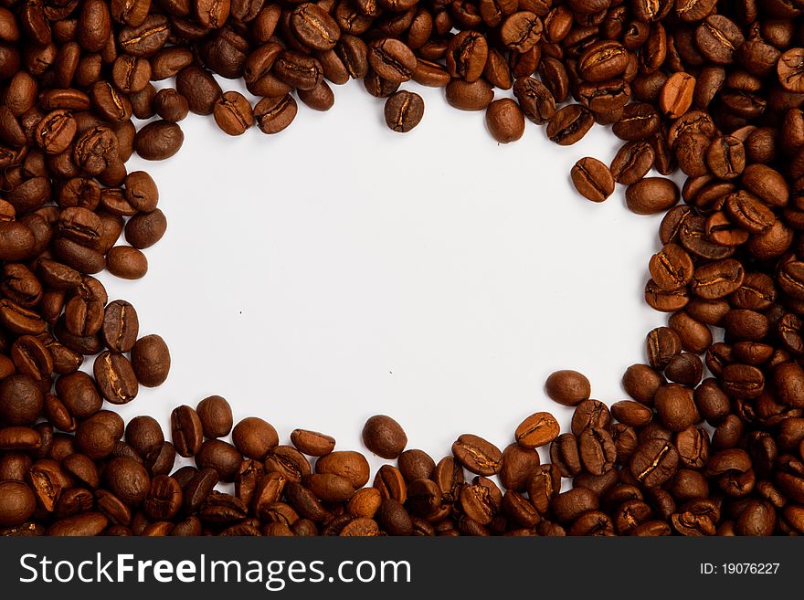 Brown roasted coffee beans. on white. Brown roasted coffee beans. on white