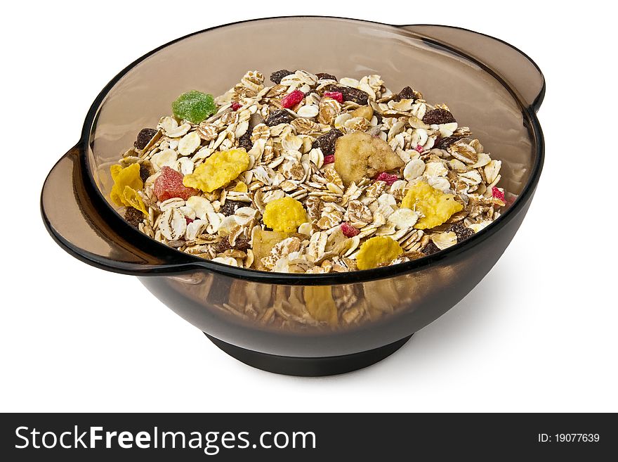 Isolated dry muesli  in a black bowl. Isolated dry muesli  in a black bowl