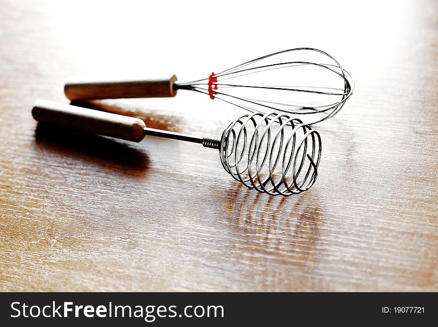 An image of two whisks on the kitchen table