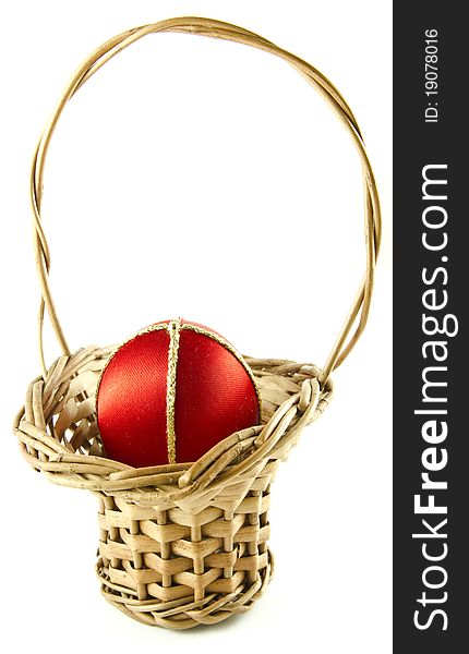 Easter egg in a wattled basket isolated on a white background