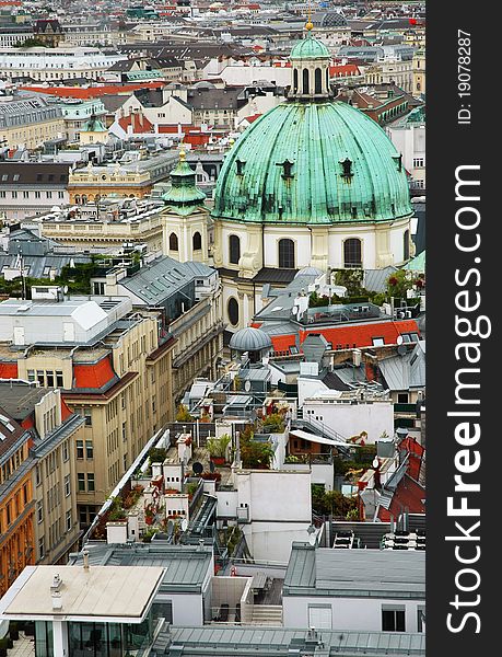 Cityscape of Vienna with St. Peter's church and gardens on a roof