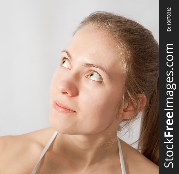 Portrait of blonde girl, looking up and left