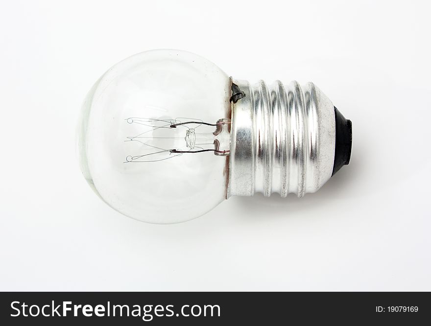 The close up macro shot of a small electric light bulb.