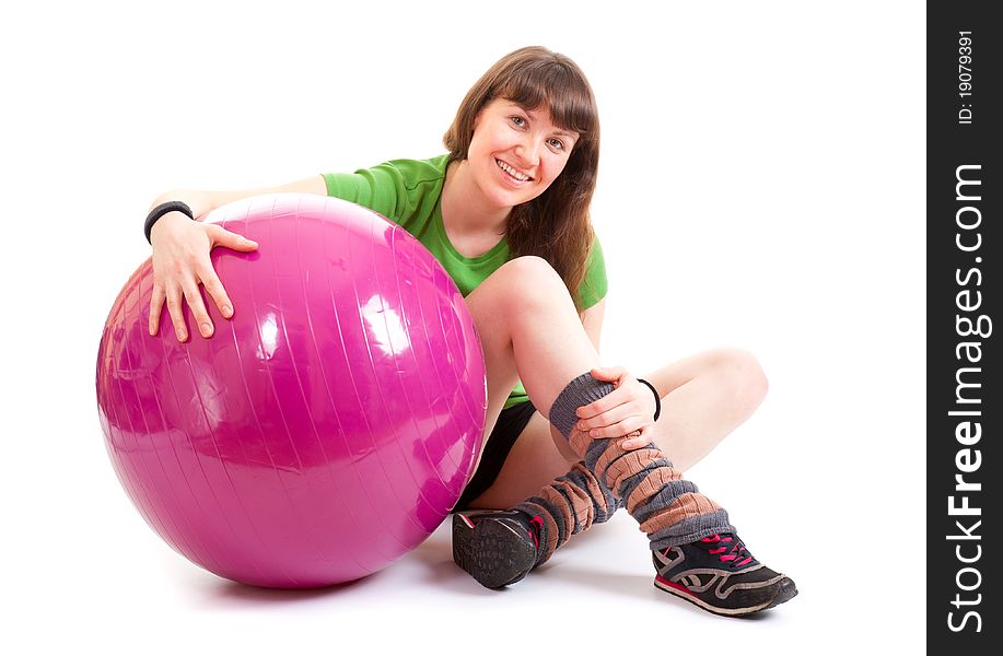 Young nice woman sitting with a big fitness ball. Young nice woman sitting with a big fitness ball