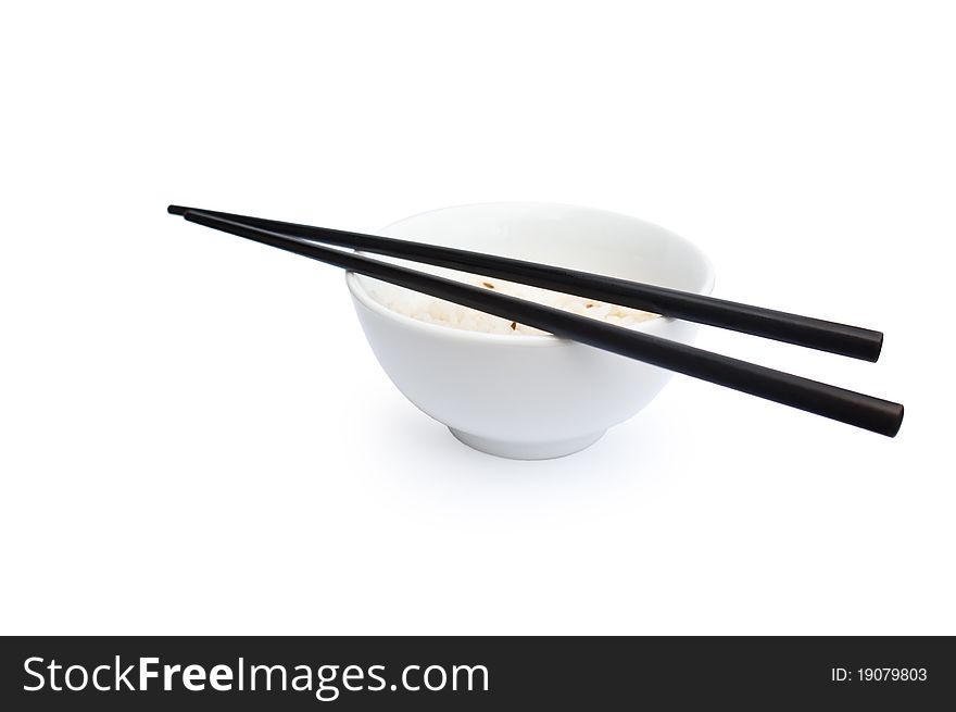 White bowl of rice with black chopsticks on the white background. White bowl of rice with black chopsticks on the white background