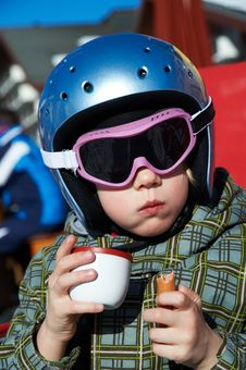 Little Girl In Helmet And Glasses Eats And Drink Stock Image Little Girl In Helmet And Glasses Eats And Drink Stock Image