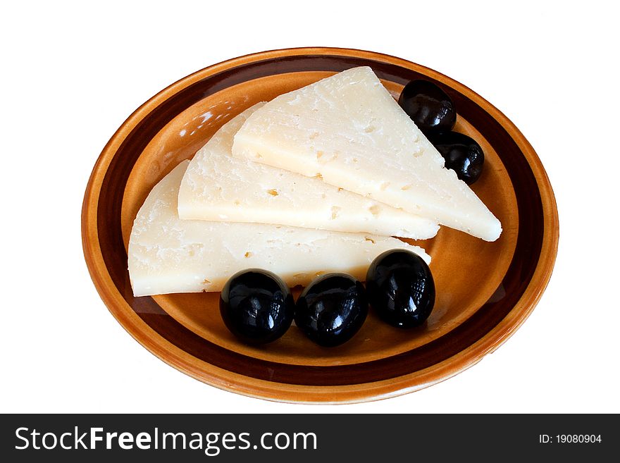 Slices of cheese and black olives on plate isolated over white