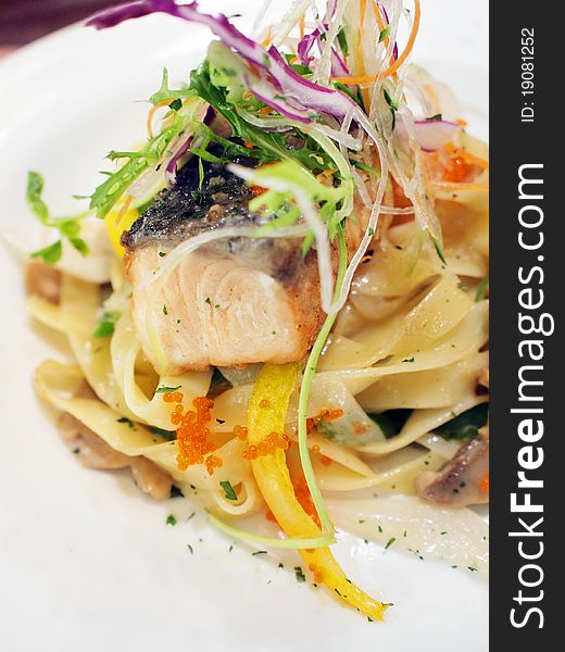 Closeup of fettuccine with grilled salmon fillet