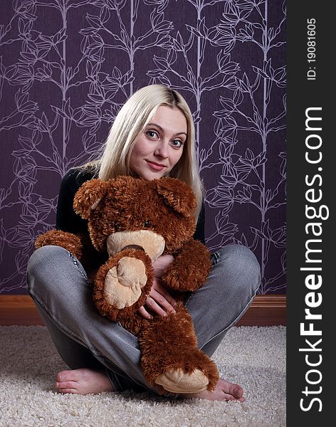 Girl embraces toy a bear. Girl embraces toy a bear