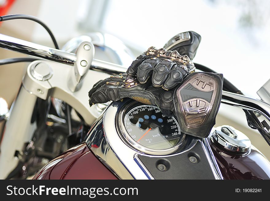 Motorcycle gloves with carbon on bike inside of showroom