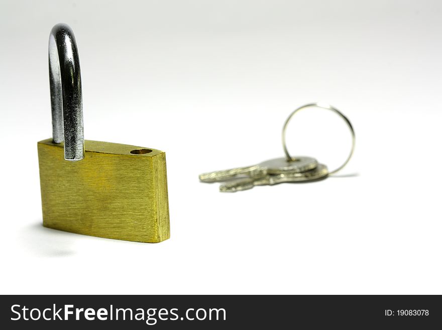 Opened padlock with the keys on background