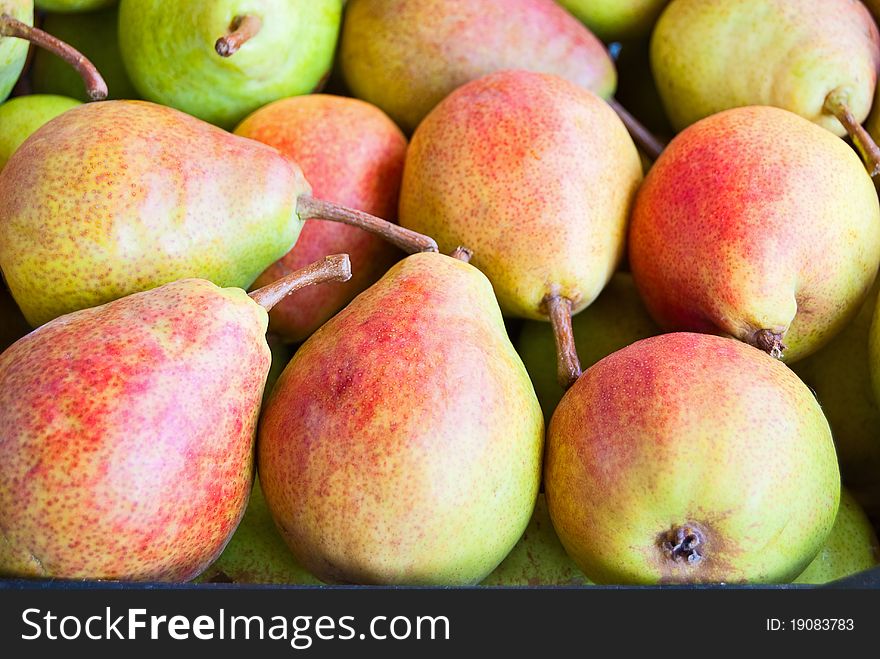 Freshly ripe pears in large boxes