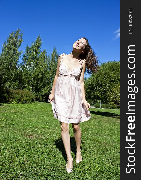 Beautiful Young Happy Woman Under Blue Sky.
