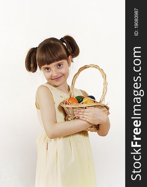 Girl keeping the basket with Easter painted eggs. Girl keeping the basket with Easter painted eggs