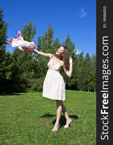 Beautiful young woman dancing with kerchief against the blue sky. Beautiful young woman dancing with kerchief against the blue sky