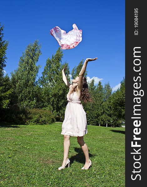 Beautiful young woman dancing with kerchief against the blue sky. Beautiful young woman dancing with kerchief against the blue sky