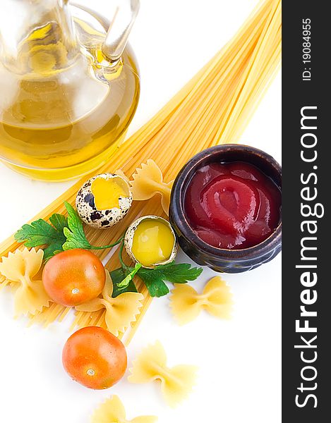 Pasta ingredients with cherry tomato, eggs, ketchup and greens