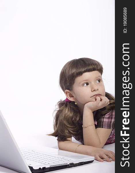 Brunette young girl lying on the floor in front of a computer. Brunette young girl lying on the floor in front of a computer.