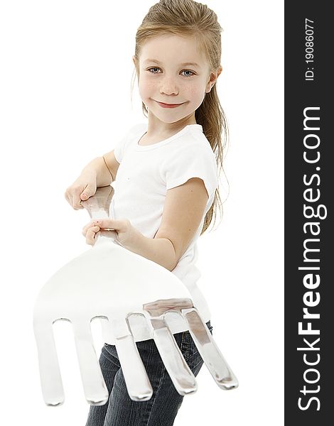 Adorable six year old caucasian girl holding giant fork over white with clipping path. Adorable six year old caucasian girl holding giant fork over white with clipping path.