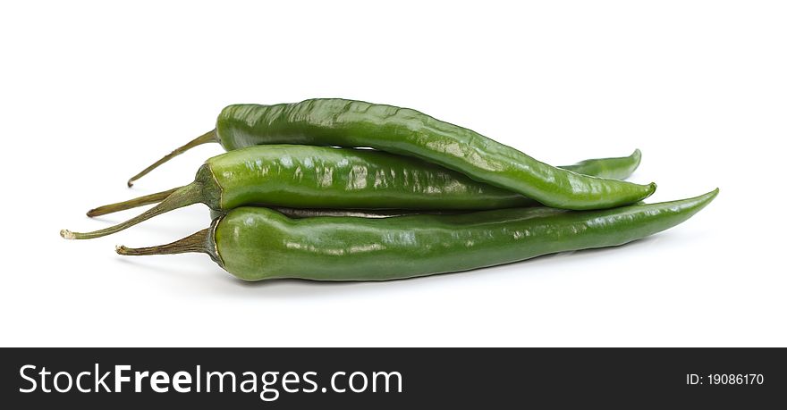 Three green chili paprikas over white background. Three green chili paprikas over white background