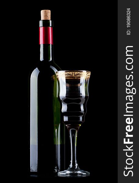 Wine bottle and wineglass on a black background