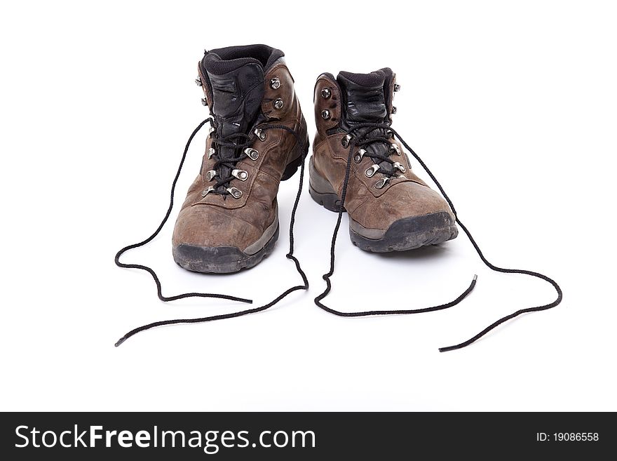 A well-worn pair of leather hiking boots on a white background.