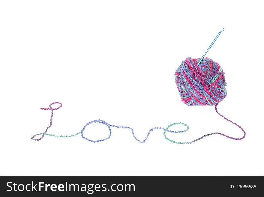 The word LOVE spelled out in multi-colored yarn isolated on white. The word LOVE spelled out in multi-colored yarn isolated on white.