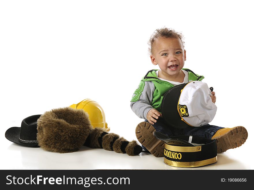 An adorable mixed-race baby trying on a many different style hats. Isolated on white. An adorable mixed-race baby trying on a many different style hats. Isolated on white.