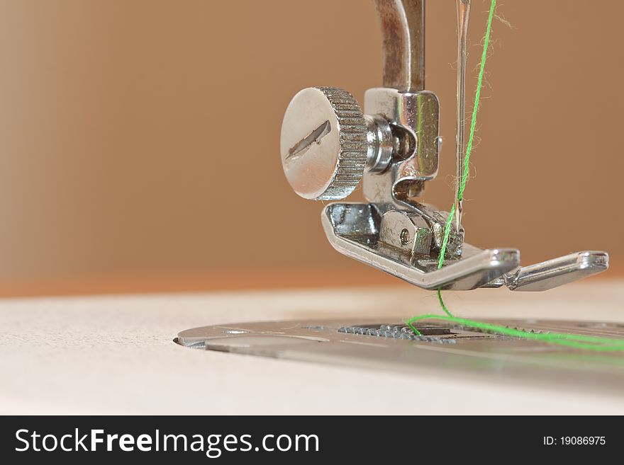 Macro shot of sewing machine with thread in needle. Macro shot of sewing machine with thread in needle.