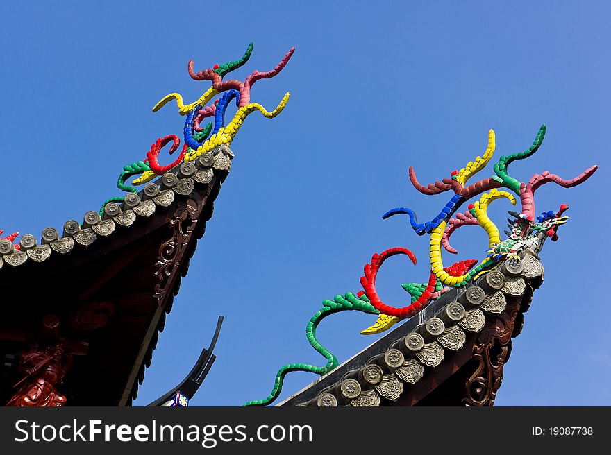 Colorful sculpture by porcelain (mythical beast and sculpt) on the eave. This the traditional temple structure for china southeast. Colorful sculpture by porcelain (mythical beast and sculpt) on the eave. This the traditional temple structure for china southeast.