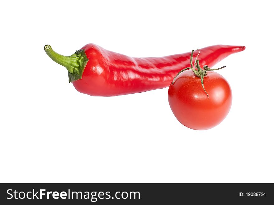 Tomato and red hot chili peppers isolated on white background